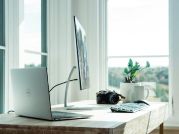 silver laptop on white table